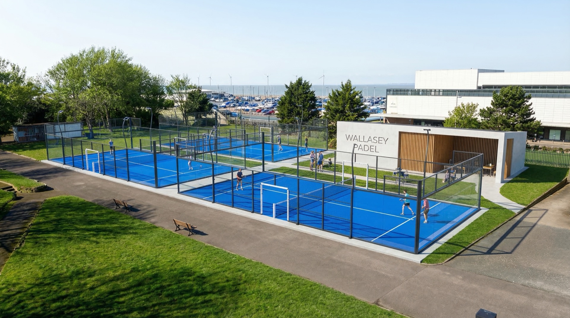 Aerial concept render of Wallasey Padel courts at Marine Park with three blue courts, clubhouse, and New Brighton coastline